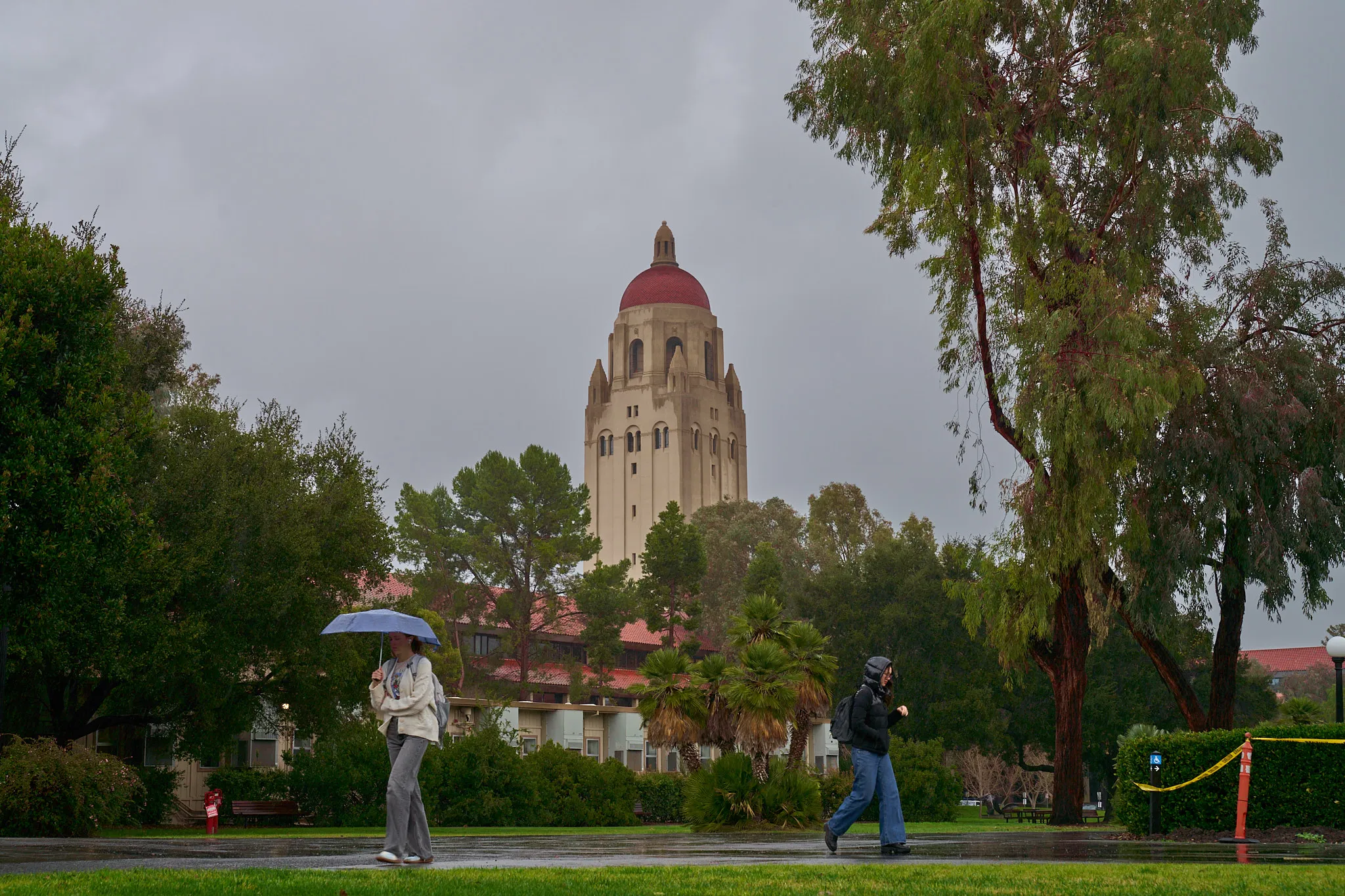 Students walk through the rain on their way to class.